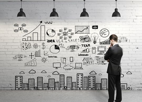 businessman looking at business concept on wall