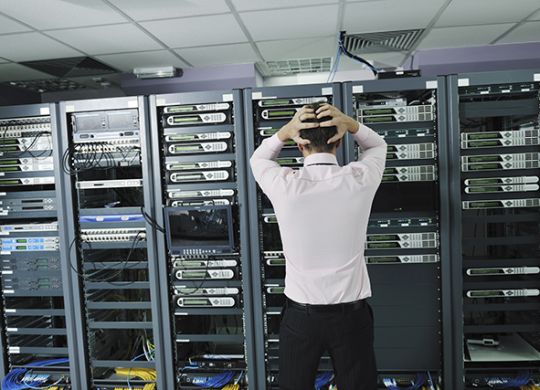 it business man in network server room have problems and looking for  disaster situation  solution