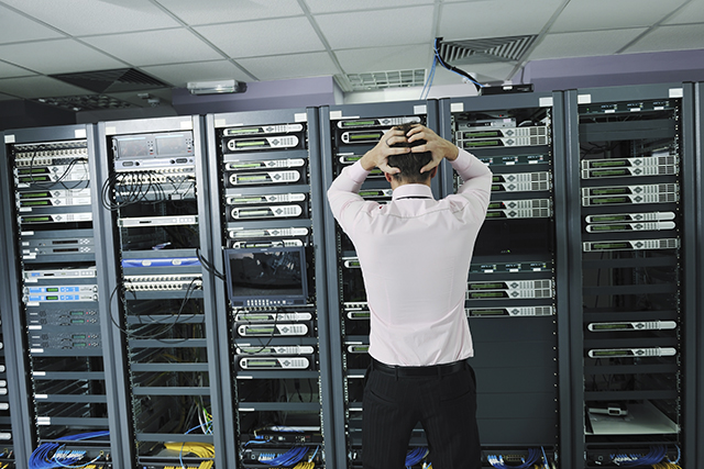 it business man in network server room have problems and looking for disaster situation solution